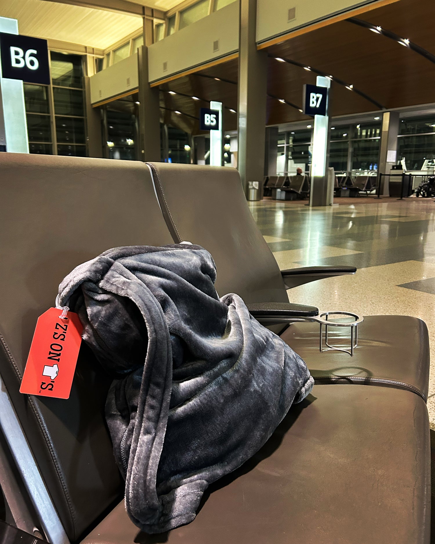 zzz's on tee's travel bag in airport